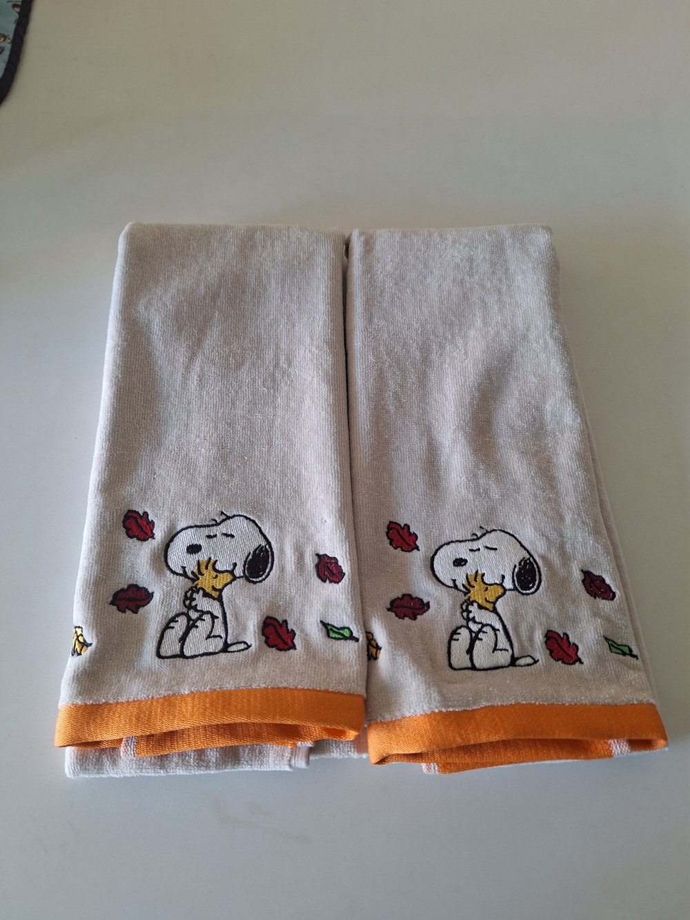 Set Of Two Peanuts Beige Hand Towels with Orange Trim And Autumn Print